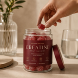 Creatine Daily Gummies jar open with hand